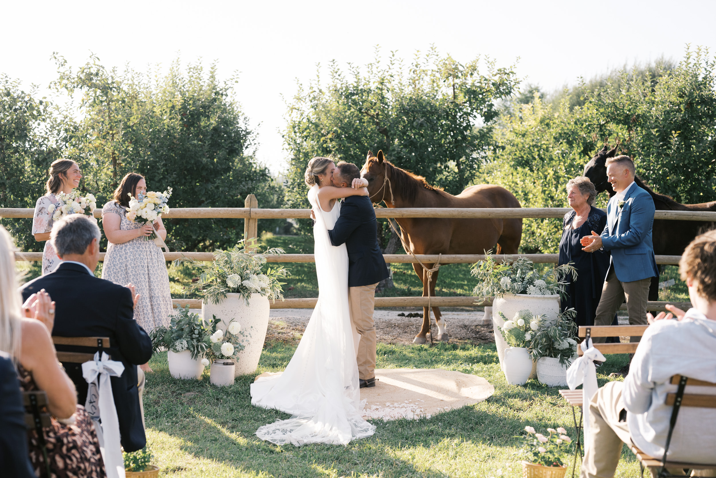 bride and groom share first kiss at wedding planned by kelowna wedding planner modrn company