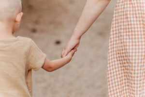 boy holds hand with his mom after counselling