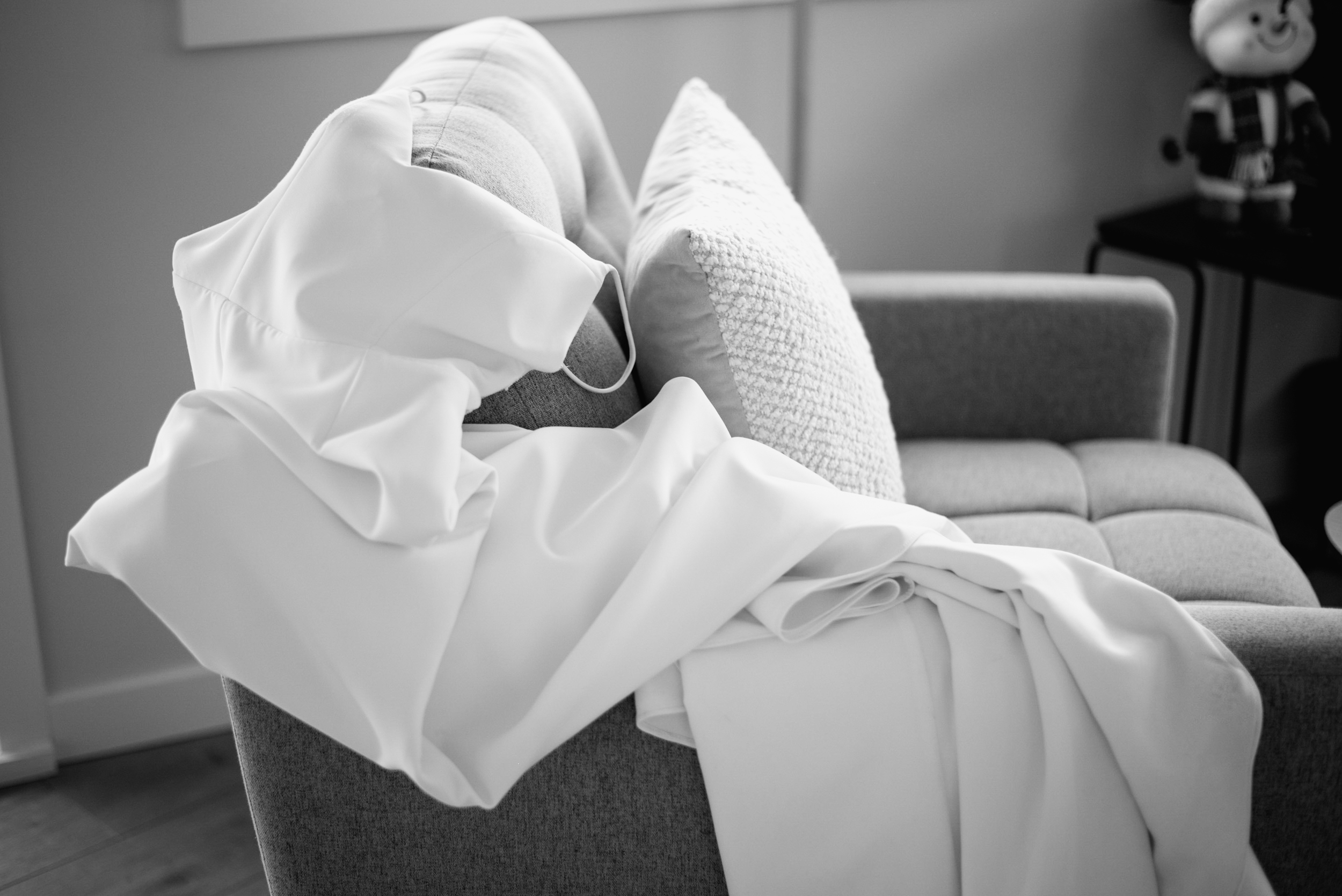bridal gown laid on chair waiting to be put on