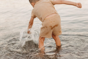 boy punches water playing in water