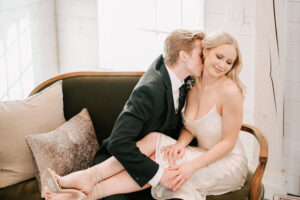 couple sitting on couch on their wedding day