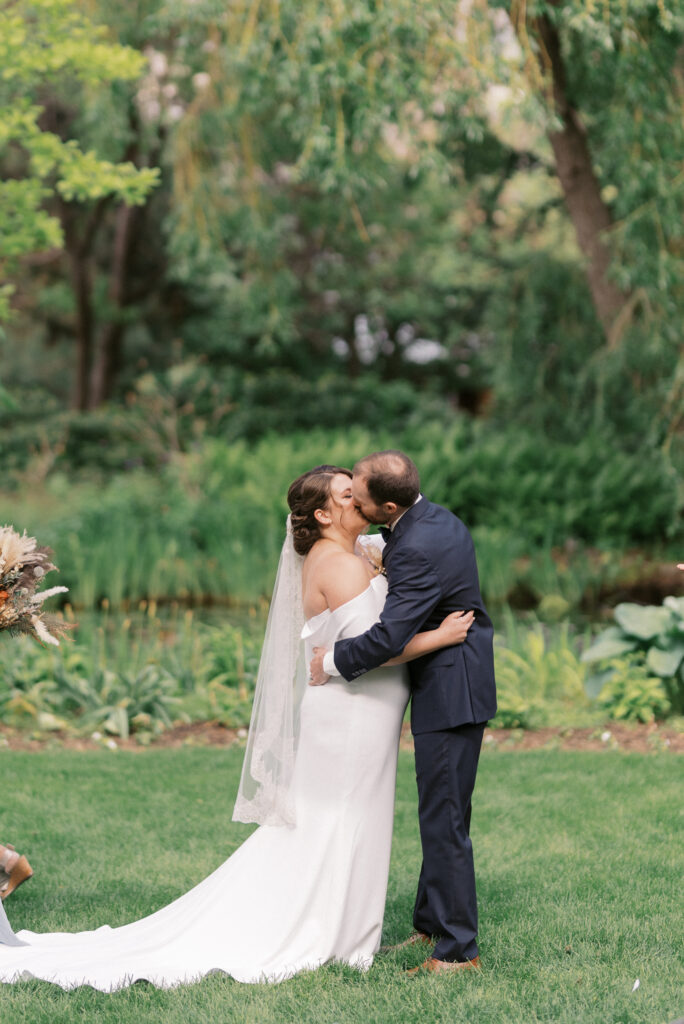 couple kiss during ceremony at a linden gardens wedding