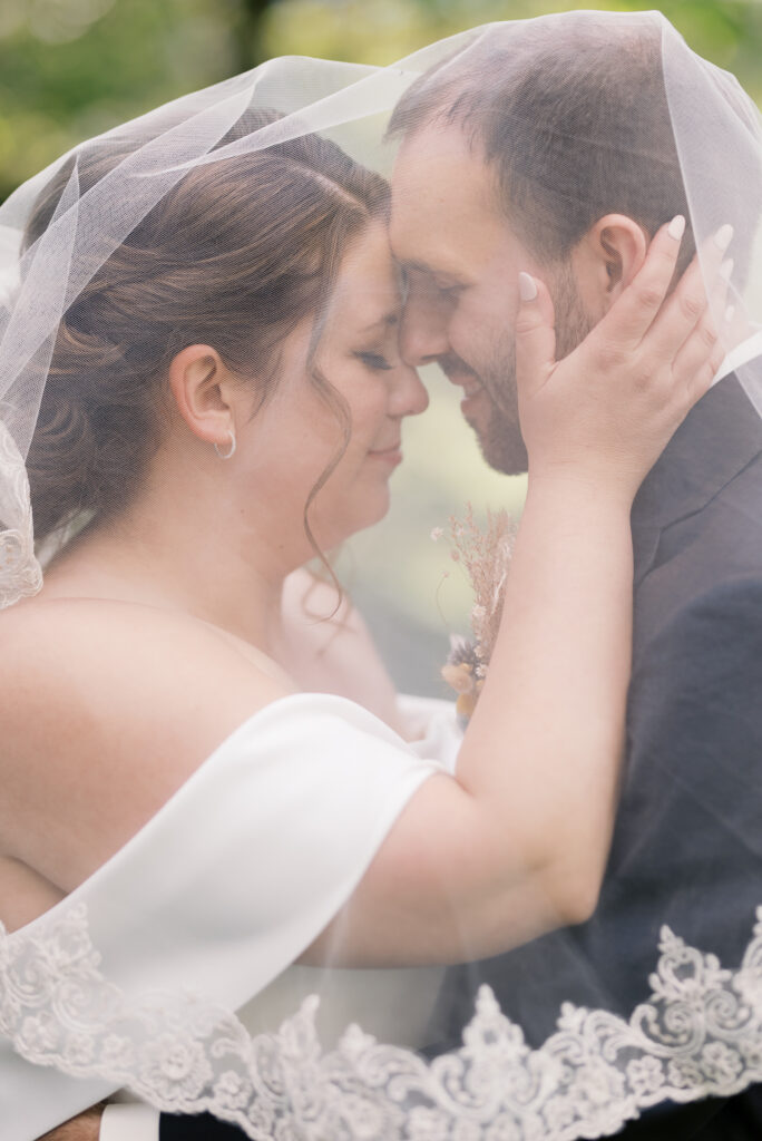 couple press foreheads together at a linden gardens wedding