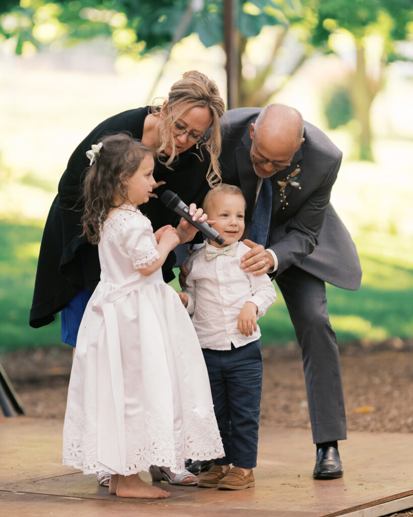 flower girl sings a song as a speech at a linden gardens wedding